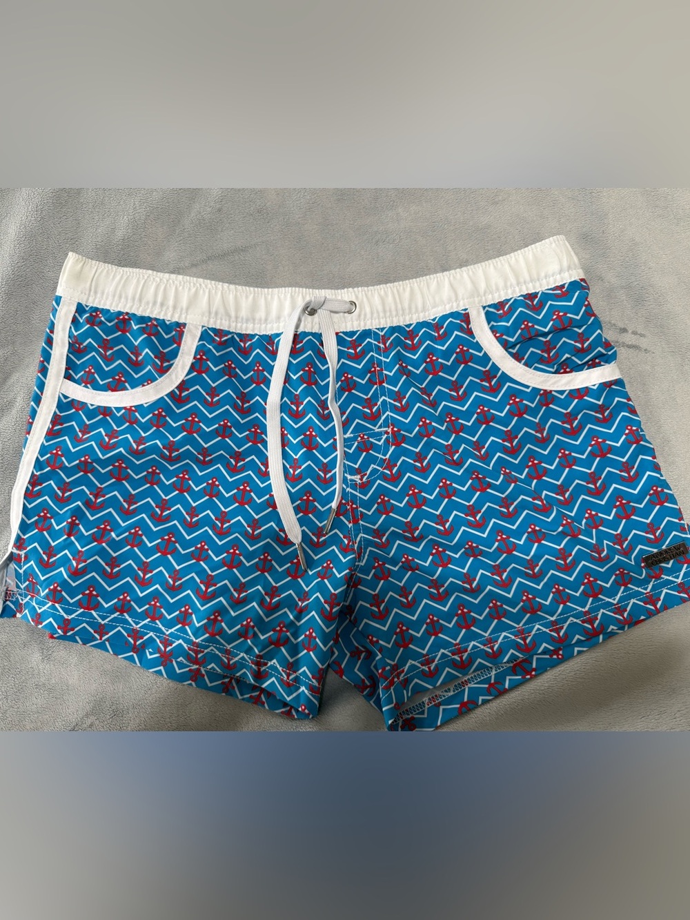 Andrew Christian blue, red and white lined swim trunks. Men’s size medium.